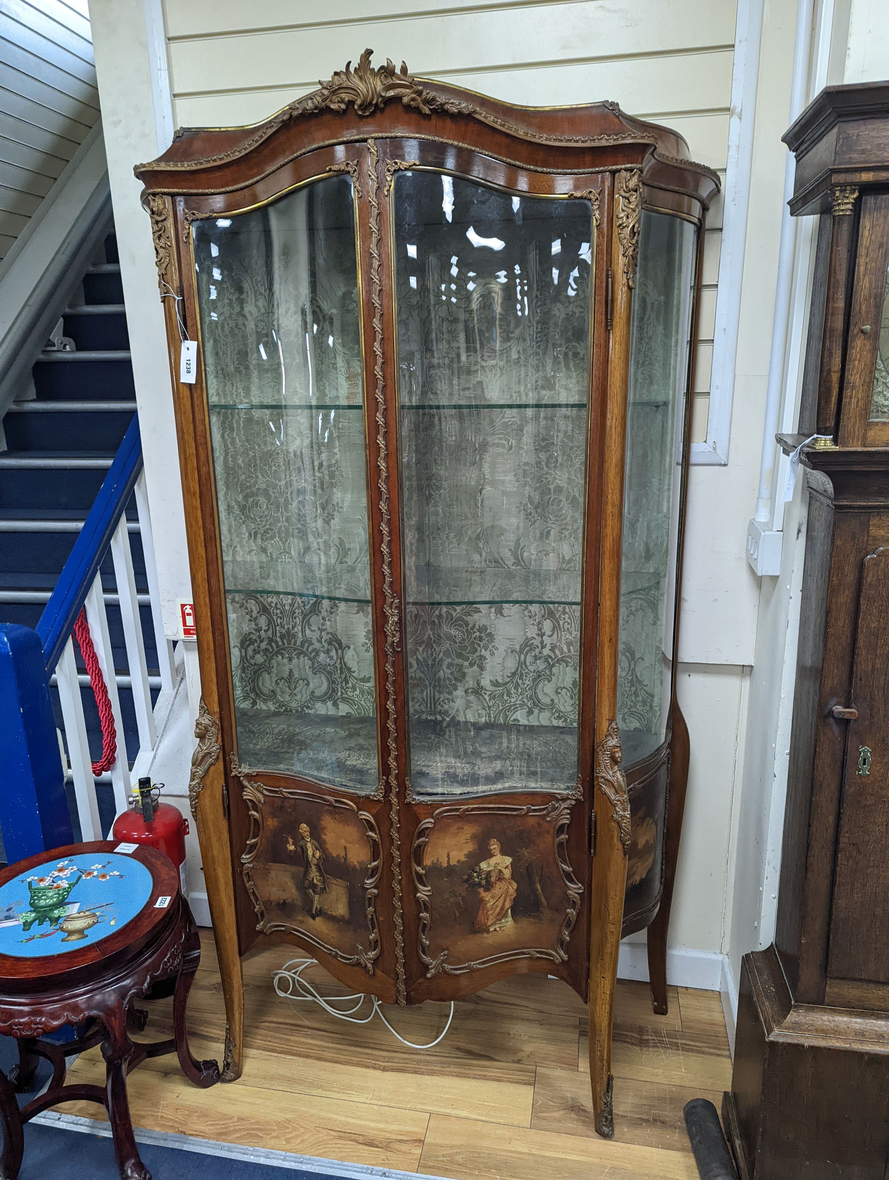 A Louis XV style mahogany serpentine vitrine with Vernis Martin style panels and gilt metal mounts, width 108cm, depth 46cm, height 193cm